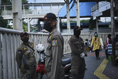 Public order policemen keep watch at the Tanah Abang textile on May 22, 2020, in Jakarta, Indonesia.