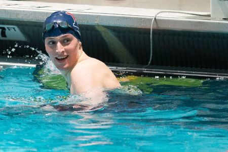 University of Pennsylvania swimmer Lia Thomas smiles after winning the 100-yard freestyle during the 2022 Ivy League Women's Swimming and Diving Championships at Blodgett Pool on February 19, 2022, in Cambridge, Massachusetts.