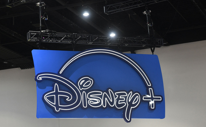 The logo of the Disney+ streaming service hangs above their booth during San Diego Comic-Con International in San Diego, California, on July 24, 2022.