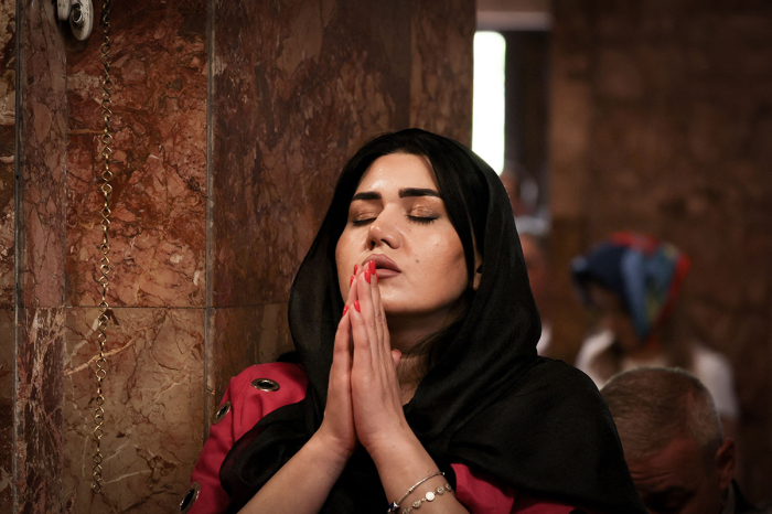 A woman prays during a service for the Nagorno-Karabakh refugees at the Saint-Sargis vicarial church as part of the nationwide prayer for Artsakh day in Yerevan, the capital of Armenia, on October 1, 2023.