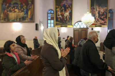 Iranian Christians attend the New Year mass at the Saint Targmanchats Armenian Church in Tehran, early on January 1, 2023.