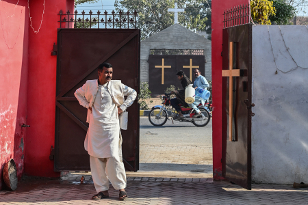 A man stands at the entrance of the rehabilitated Presbyterian Church on a Christmas Day in Jaranwala on December 25, 2023. More than 80 Christian homes and 19 churches were vandalized in an hours-long riot in Jaranwala in Punjab province on August 16, 2023, after allegations that a Quran had been desecrated spread through the city.