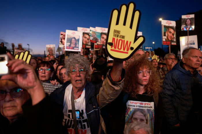 Relatives and supporters of Israeli hostages held in Gaza since the October 7 attacks by Hamas militants lift placards during a demonstration in front of the Israeli parliament in Jerusalem on April 7, 2024, amid the ongoing conflict in the Gaza Strip between Israel and the Palestinian militant Hamas movement.