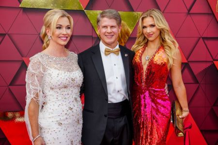 Clark Hunt (middle) with his wife, Tavia Shackles (left), and daughter Gracie Hunt (right) walking the red carpet at the Kansas City Chiefs ring ceremony at Union Station on June 15, 2023, in Kansas City, Missouri.