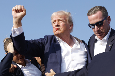 Republican presidential candidate former President Donald Trump is rushed offstage during a rally on July 13, 2024, in Butler, Pennsylvania.