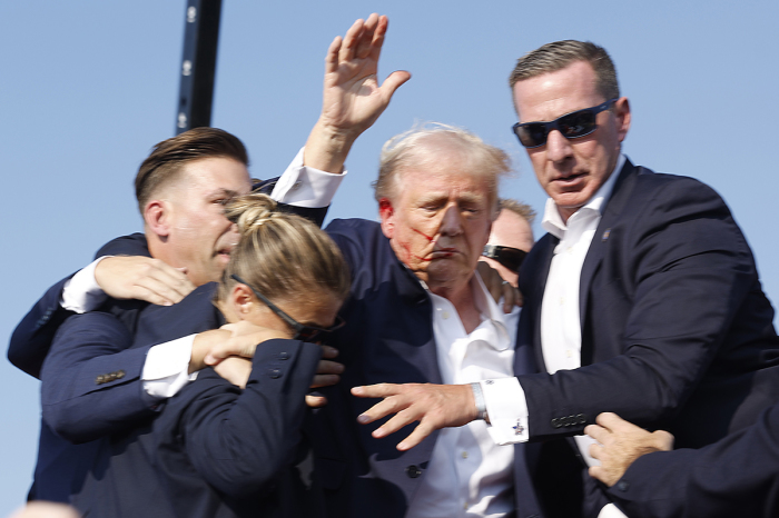 Republican presidential candidate former President Donald Trump is rushed offstage during a rally on July 13, 2024, in Butler, Pennsylvania.