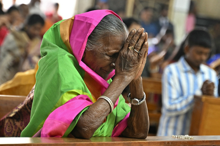 A devotee offers prayers on the occasion of Christmas at the Infant Jesus Church in Bengalurum, India, on Dec. 25, 2024.
