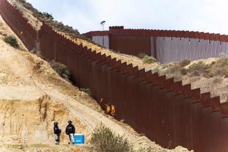 National Guard officers monitor the border wall between Mexico and the U.S. during the deployment of National Guard troops at the U.S. Border on February 5, 2025 in Tijuana, Mexico. Mexico President Claudia Sheinbaum announced the deployment of 10,000 troops along the Mexico-U.S. border as part of an agreement with Trump's administration to delay an increase of 25% tariffs on exported goods.