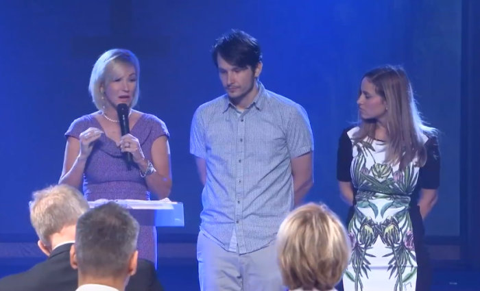 Paula White (L) announces an official change to the name of her New Destiny Christian Center in Apopka, Florida, on Sunday and installs her son, Brad Knight (C), as senior pastor along with his wife, Rachel (R).